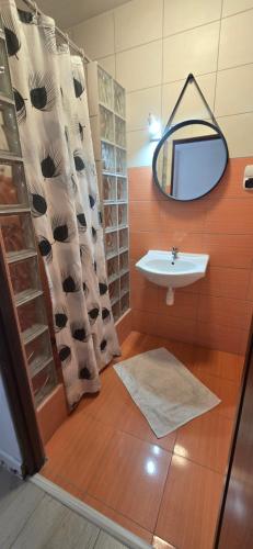 a bathroom with a sink and a mirror at Promyk 2 in Rewal