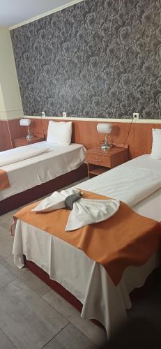 a hotel room with two beds in a room at Atlantic Hotel in Budapest