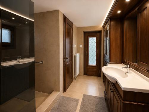a bathroom with two sinks and a shower at The Cottage in the Trees in Tsagarada