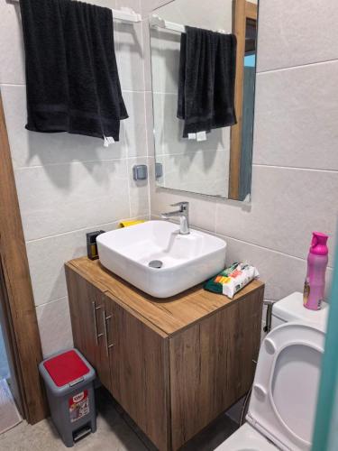 a bathroom with a sink and a toilet at Résidence Leyla in Abidjan