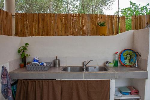 a kitchen counter with a sink and a fence at Bellissima Bell Tent - Romantic Glamping Retreat in Nature in Tortosa