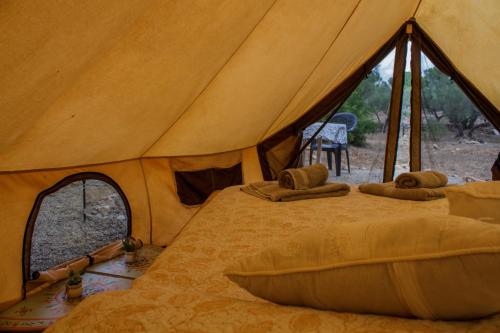 a tent with a bed with pillows in it at Bellissima Bell Tent - Romantic Glamping Retreat in Nature in Tortosa