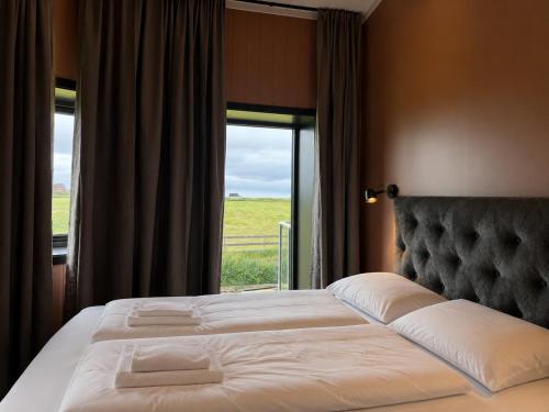 a bedroom with a large bed with a window at Flakstad beach house Silo A in Vareid