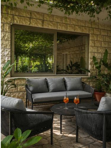 a patio with a couch and chairs and a table at Cozy house Luana in Lopud