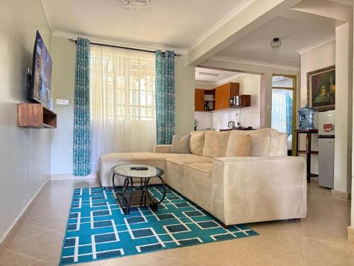 a living room with a couch and a table at MILIMANI DRIVE LIVINGs in Kisumu