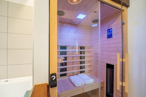 a sauna with a glass shower in a room at Brkinka Apartments in Vremski Britof