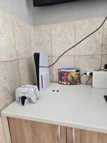 a counter top with a video game system and a camera at Lina in Dobrota