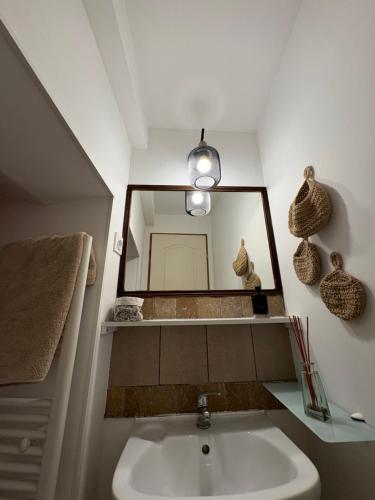 a bathroom with a sink and a mirror at A Casuccia Sischese in Sisco
