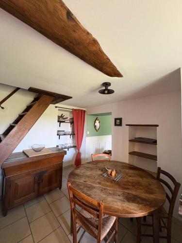 a dining room with a wooden table and chairs at A Casuccia Sischese in Sisco