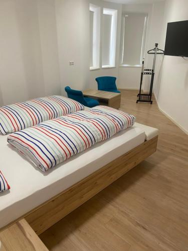 two beds are sitting in a room with wood at Gästehaus Jasmin in Lindau