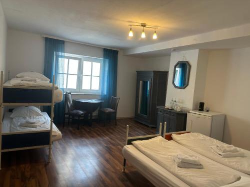 a room with two bunk beds and a table at Gästehaus Rachinger in Pappenheim