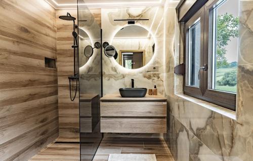 a bathroom with a sink and a shower at Kuća za odmor Šum slapa in Karlovac