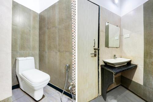 a bathroom with a toilet and a sink at FabHotel Saanvi Paradise in Bhopal