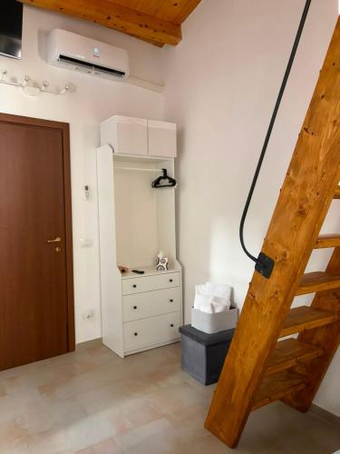 a room with a staircase and a dresser and a bedroom at Ai Sette Scalini in Larino