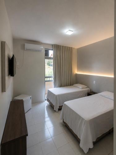 a hotel room with two beds and a television at Hotel Executivo formosa in Formosa