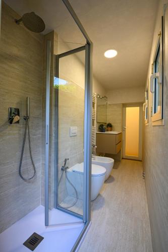 a bathroom with a shower and a tub and a toilet at Dimora l'Arancio in Lucca