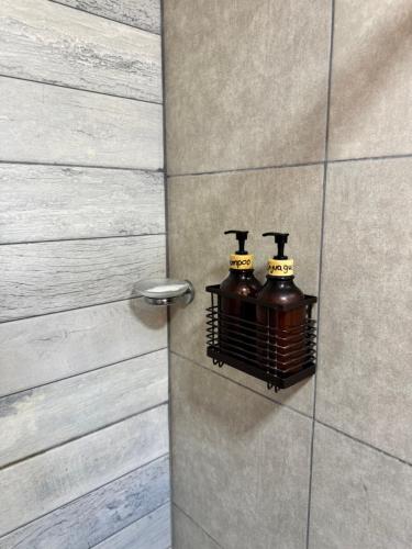 a bathroom with two bottles on a wall at Deptosxdia in Perito Moreno