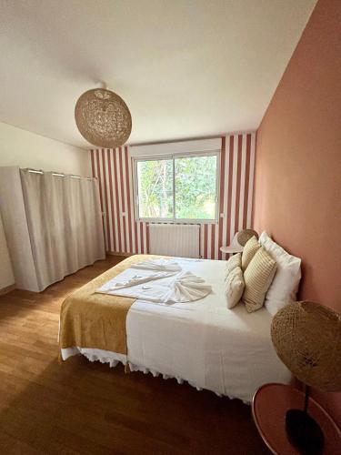 a bedroom with a large bed and a window at Casascope in Jaunay-Clan