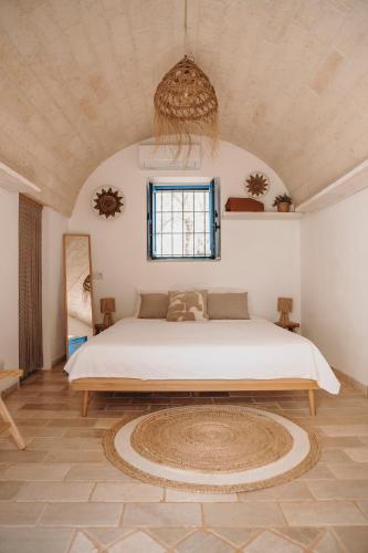 a bedroom with a large bed in a room at Trullo Serenità Charming Trullo with Private Pool in Apulië in Ceglie Messapica