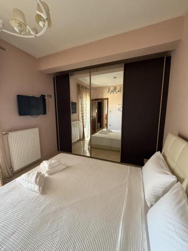 a bedroom with a large bed with a large mirror at Kali's home in Komotini