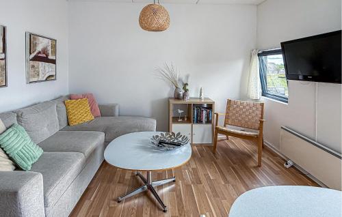 a living room with a couch and a table at Fanø Bad, Lejl 56 in Fanø