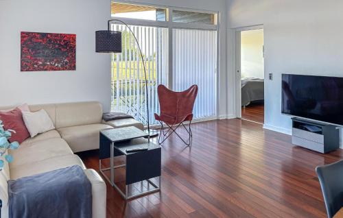 a living room with a couch and a flat screen tv at Awesome Home In Otterup With Wifi in Otterup