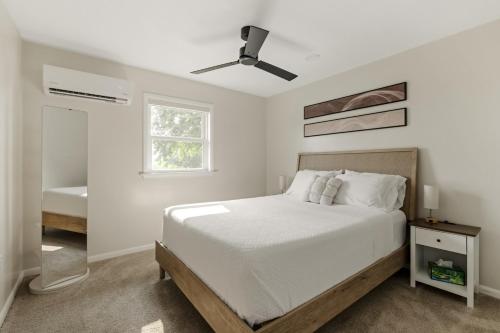 a white bedroom with a bed and a ceiling fan at New! Cozy Family Getaway: Amish Farmland|Patio|Washer & Dryer|Central Lancaster County in Ronks