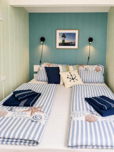 a bedroom with two beds with blue and white stripes at Finnenhaus 8 in Lübeck