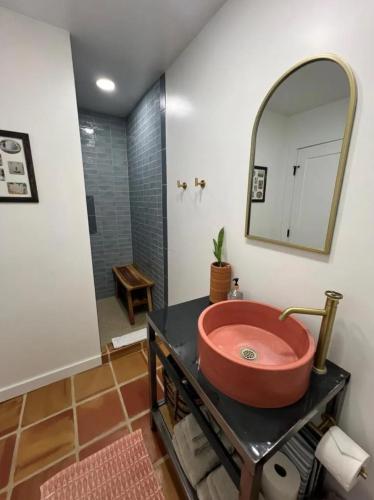 a bathroom with a red sink and a mirror at Pik Pak in Marfa
