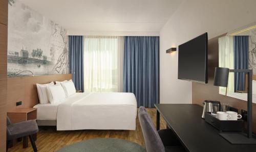 a hotel room with a bed and a desk at Park Plaza Amsterdam Airport in Lijnden