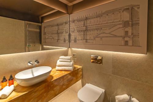 a bathroom with a sink and a toilet at Domus Teatro di Pompeo in Rome