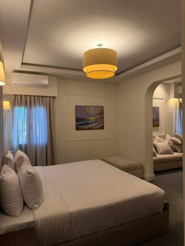 a bedroom with a large bed with a yellow light at IOS Village & Hotels in El Alamein