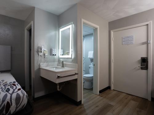 a bathroom with a sink and a toilet at Colonial Brick Inn & Suites in New Milford