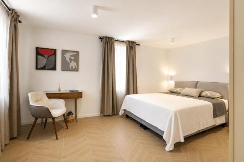 a bedroom with a bed and a desk and a chair at Villa Mater in Trogir