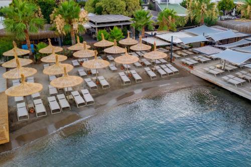 an aerial view of a resort with umbrellas and chairs at Costa Farilya Special Class Hotel Bodrum in Gundogan
