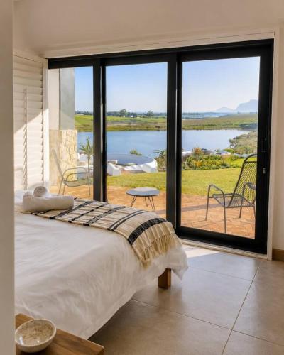 a bedroom with a bed and a view of a lake at Farmstead at ECS winery in Lake Marina