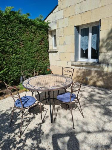 a table with two chairs and a table and a table and chairs at La Dive Ligérienne - Gîte 2 chambres in Bourgueil