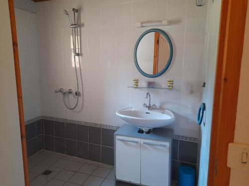 a bathroom with a sink and a mirror at Les 3 Vignobles in Pardaillan