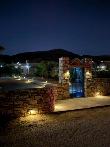 a stone building with a blue door at night at Horizon House in Paros, Cyclades in Drios