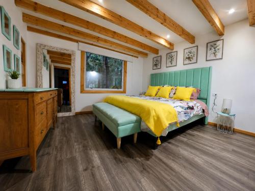 a bedroom with a bed and a dresser and a window at Casa de las Flores in Panguipulli