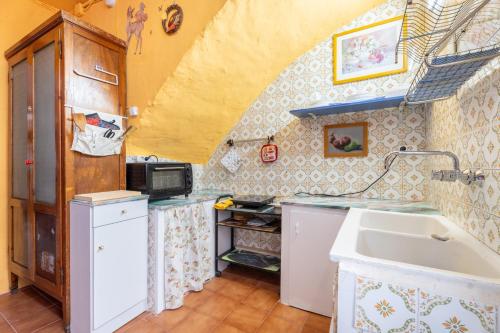 a small kitchen with a sink and a counter at Casa Ratón Pérez in Navarrés