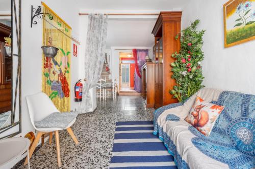 a living room with a blue couch and a chair at Casa Ratón Pérez in Navarrés