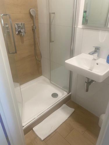 a bathroom with a shower and a sink at Gästehaus Jasmin in Lindau