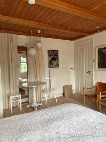 a bedroom with a bed and a table and chairs at Sølyst in Silkeborg
