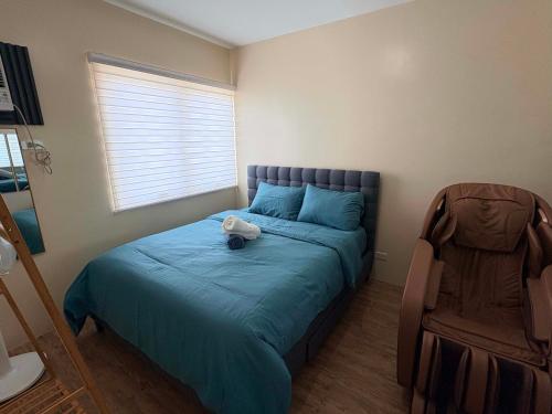 a bedroom with a bed with a stuffed animal on it at Penthouse Nook - Ananda square in Manila
