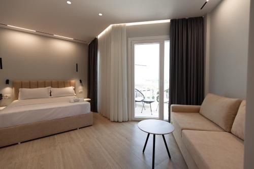 a hotel room with a bed and a couch at Sirena Garden Resort in Tale
