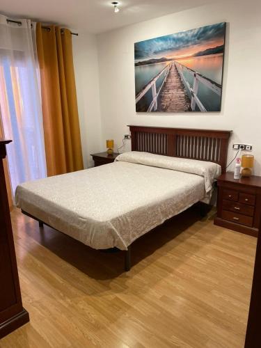 a bedroom with a bed and a painting on the wall at House Atarfe LINING1 in Atarfe