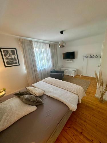 a bedroom with a large bed and a television at Geräumige Wohnfühloase mit 3 Schlafzimmern in Garbsen