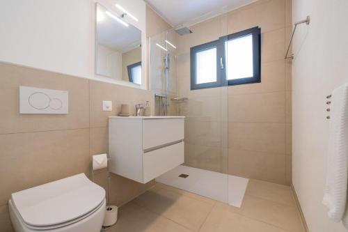a bathroom with a toilet and a sink and a mirror at Pure living Apartment in Zürich Oerlikon in Zurich