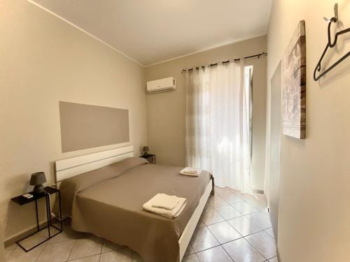 a bedroom with a bed with two towels on it at La Ginestra in Corleone